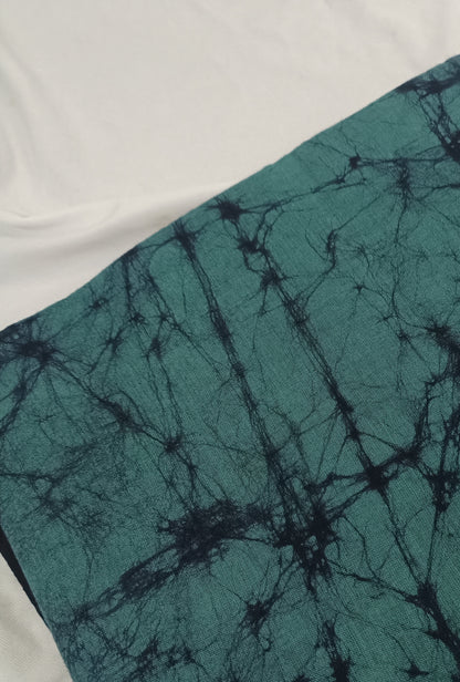 Teal fabric with black tie-dye pattern on a white background