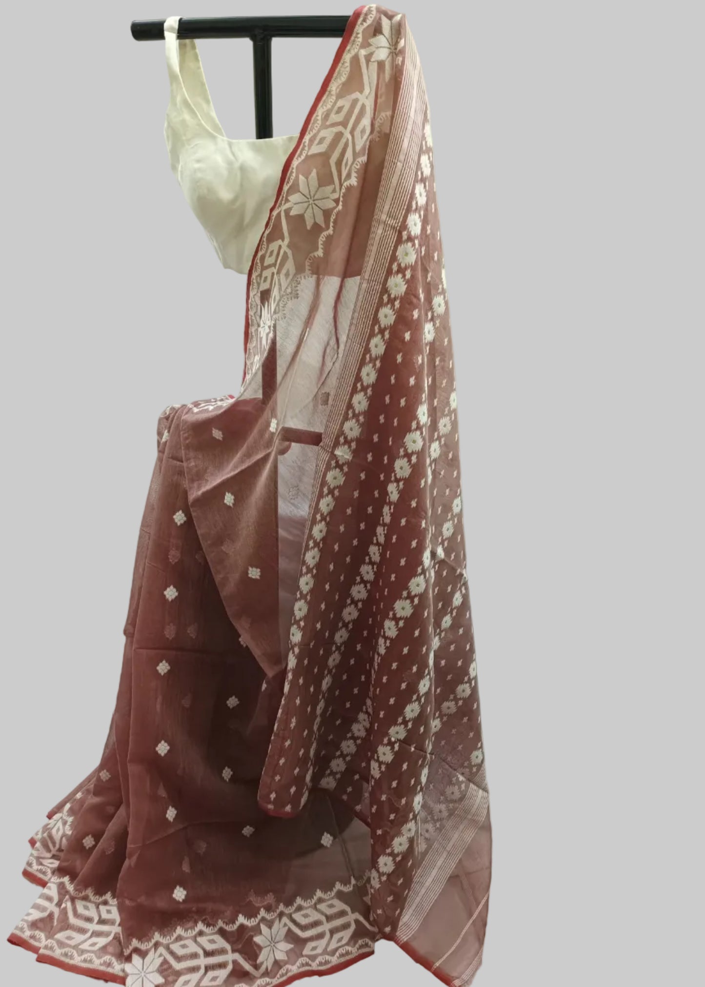 Red and white embroidered dupatta draped over a mannequin against a white curtain background