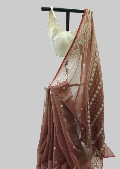 Red saree with white patterns on a mannequin against a white background