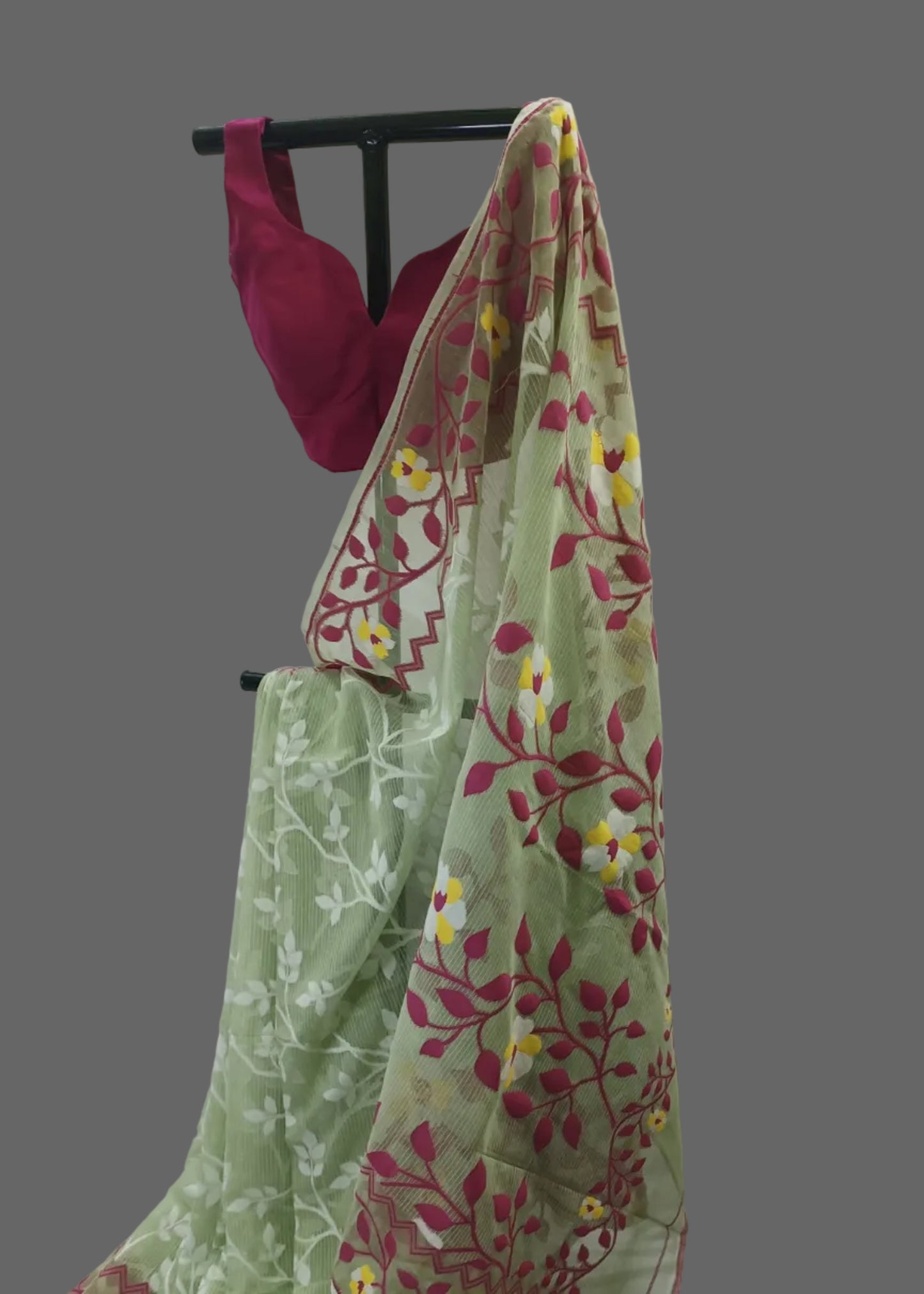 Green floral saree with a pink blouse on a white background