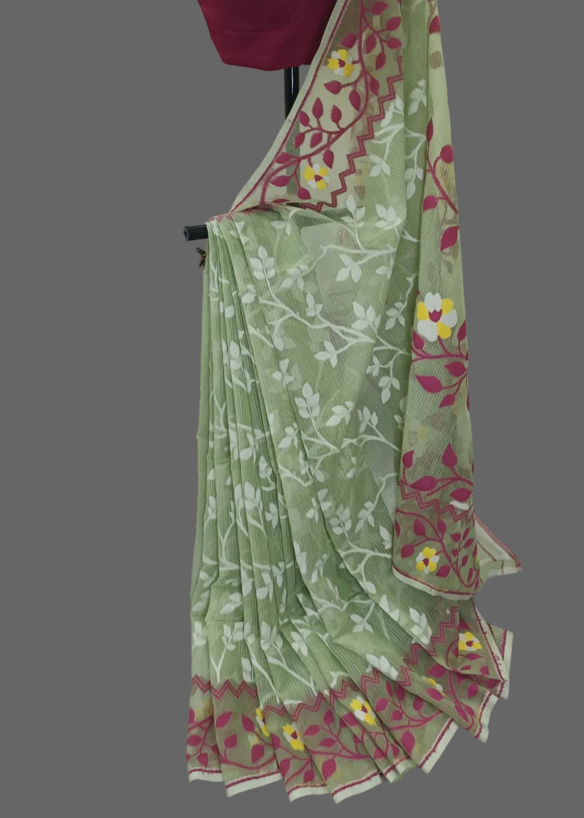 Green saree with floral patterns and a pink blouse on a white background