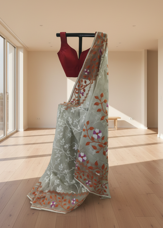 Light blue saree with floral patterns on a wooden floor