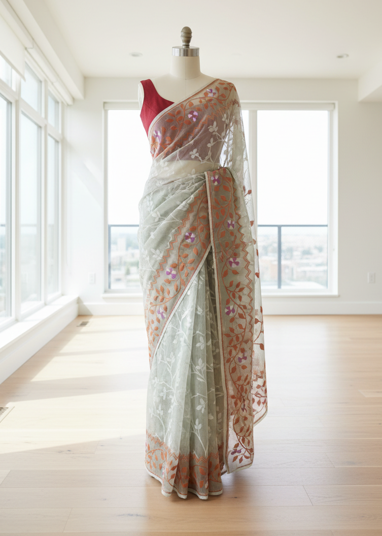 Saree with jamdani floral patterns on a mannequin in a bright room.