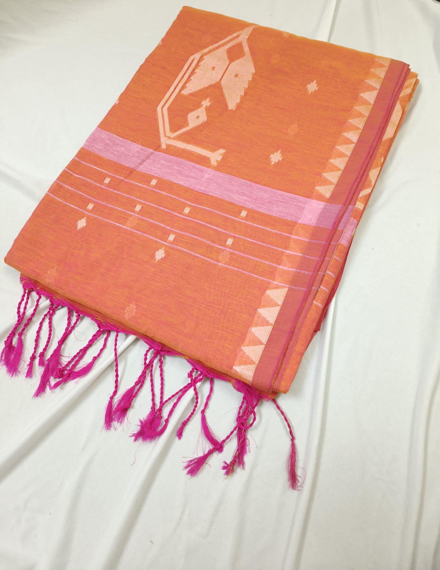 Orange fabric with pink accents and fringes on a white background