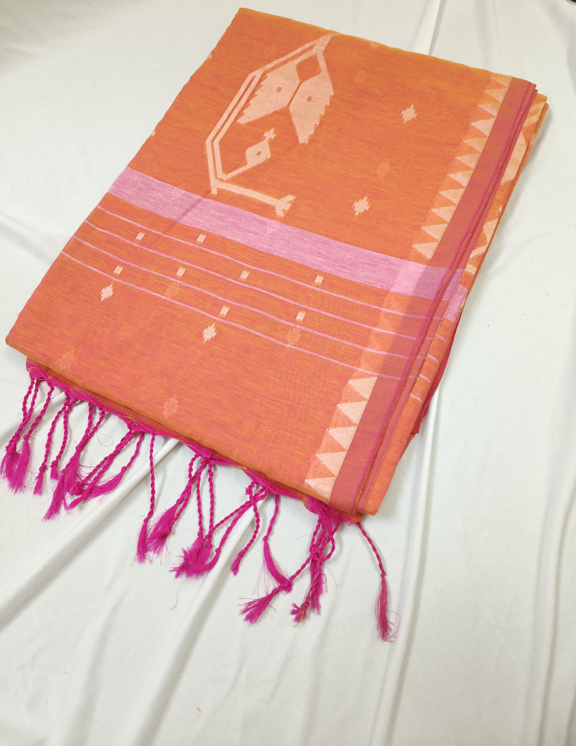 Orange fabric with pink accents and fringes on a white background