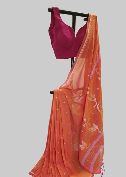 Orange saree with pink border and magenta blouse on a black stand against a white background