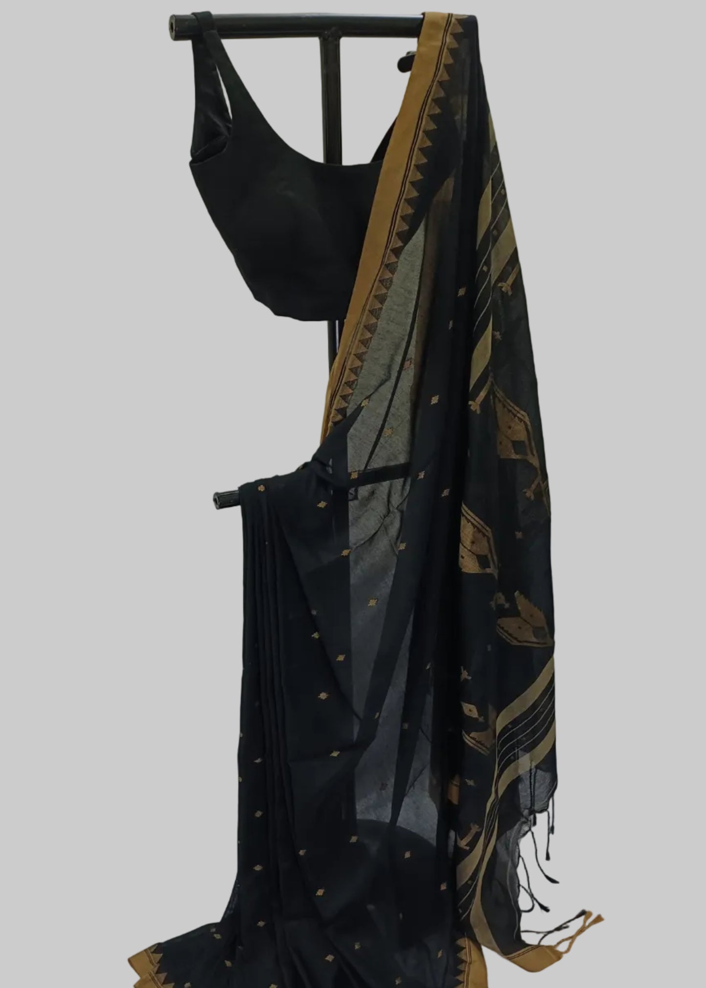 Black saree with gold border on a white background