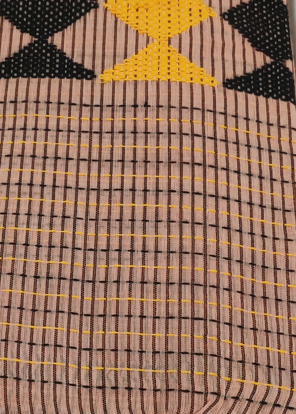 Close-up of fabric with geometric pattern on a light blue background