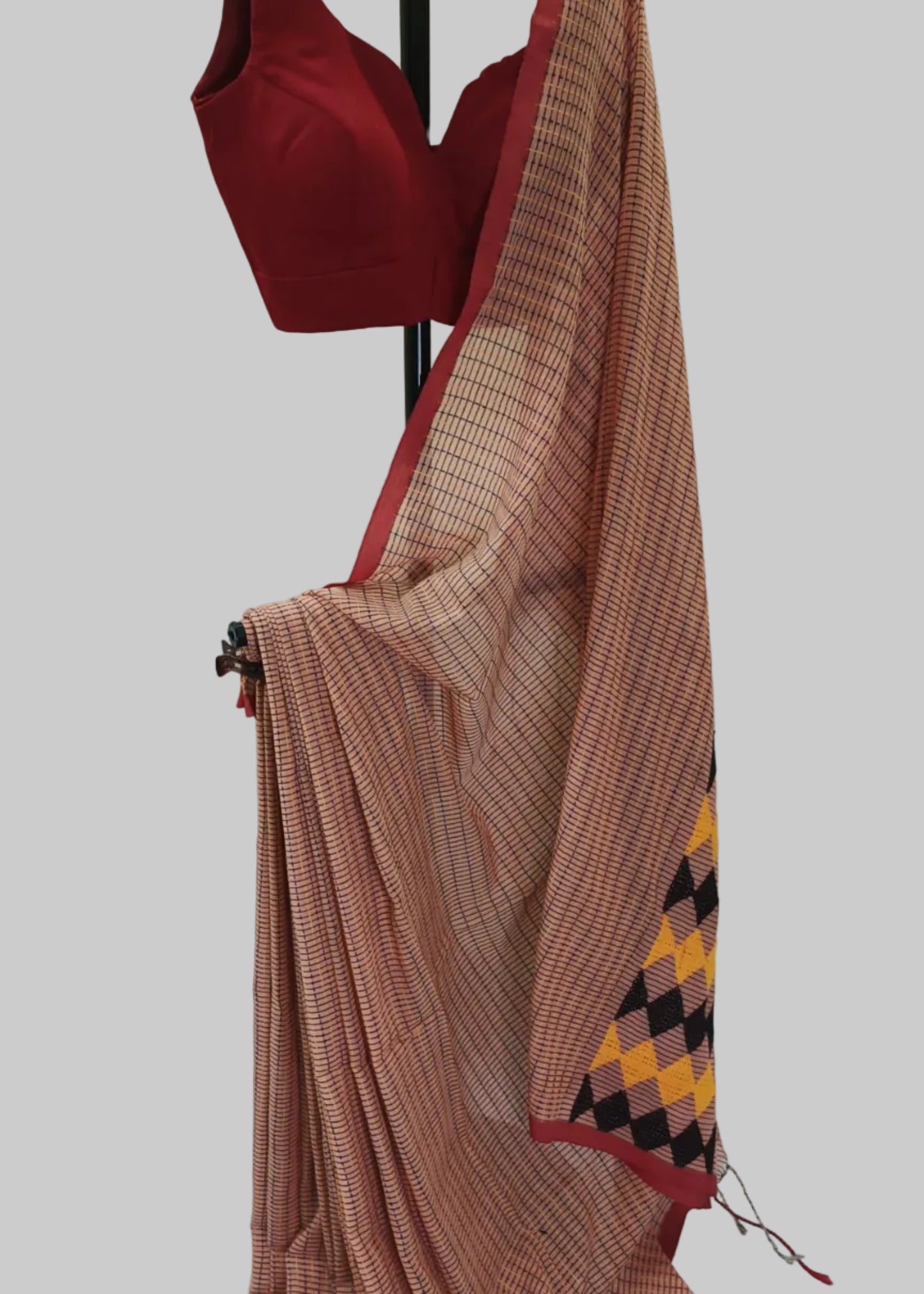 Red blouse and brown saree with geometric pattern on a white background