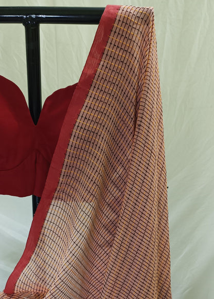 Red blouse with a checkered scarf draped over it on a white background
