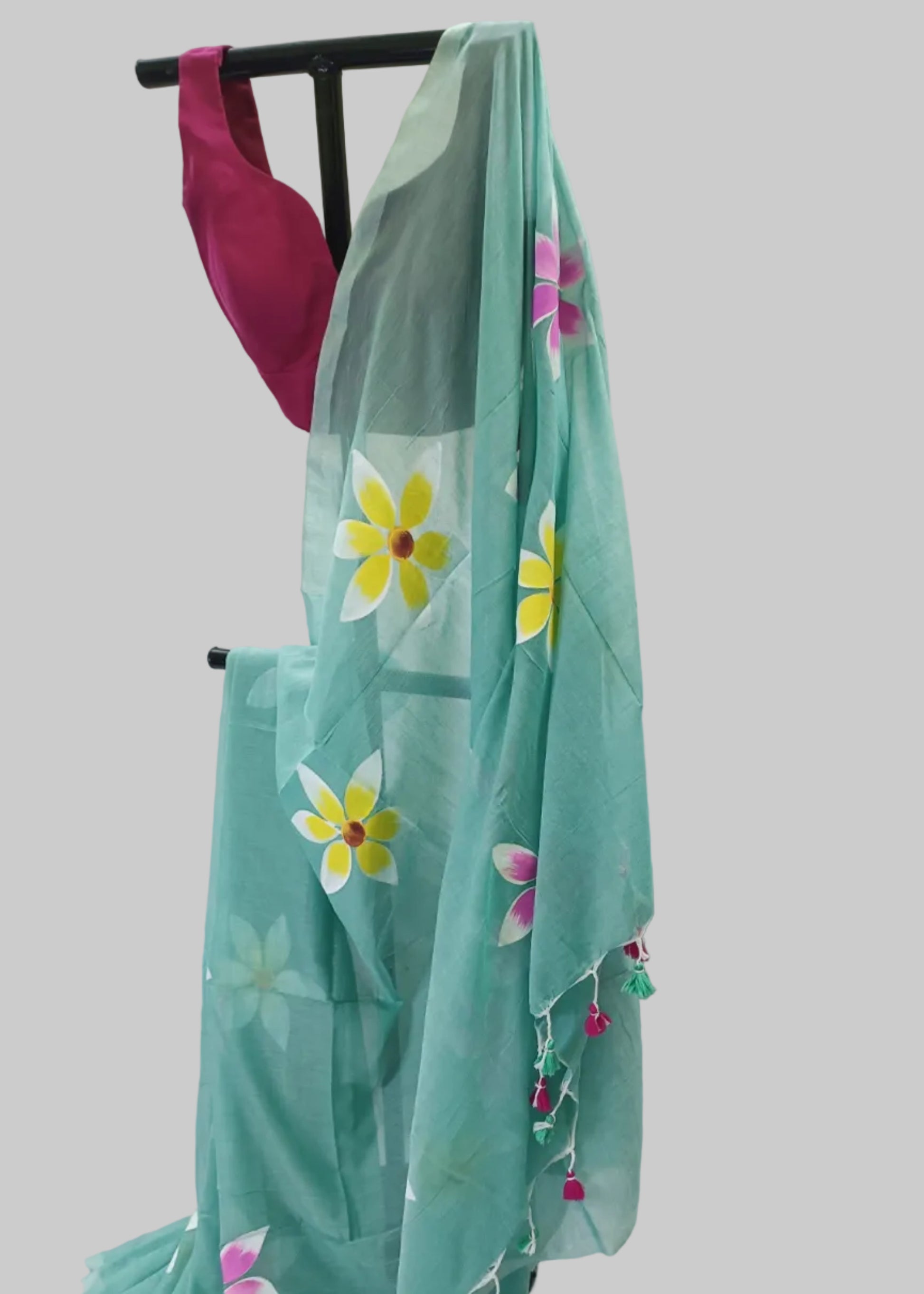 Turquoise saree with floral patterns on a white background