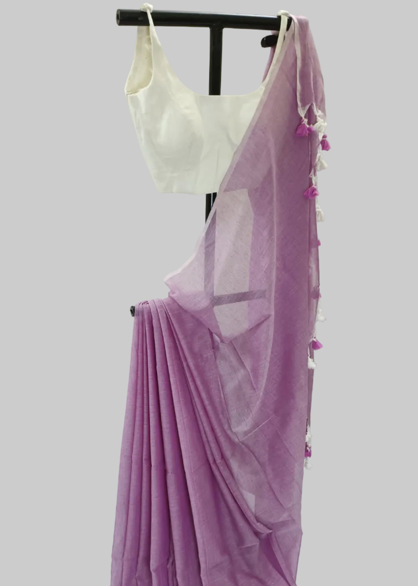 Purple saree with white blouse on a mannequin against a white background