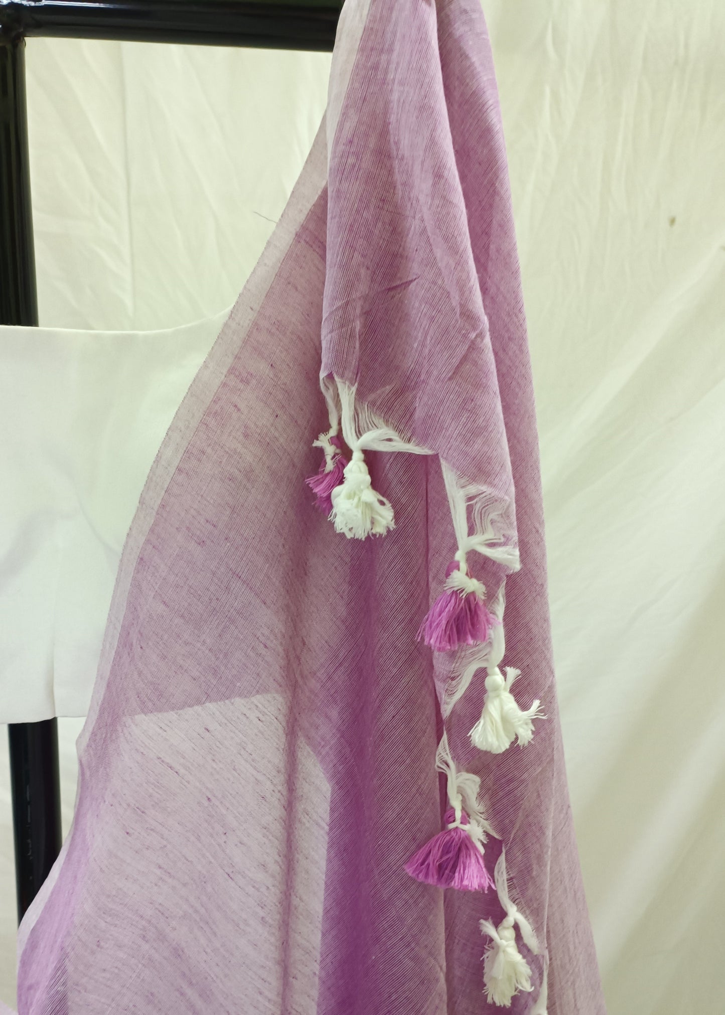 Purple saree with tassels on a white background