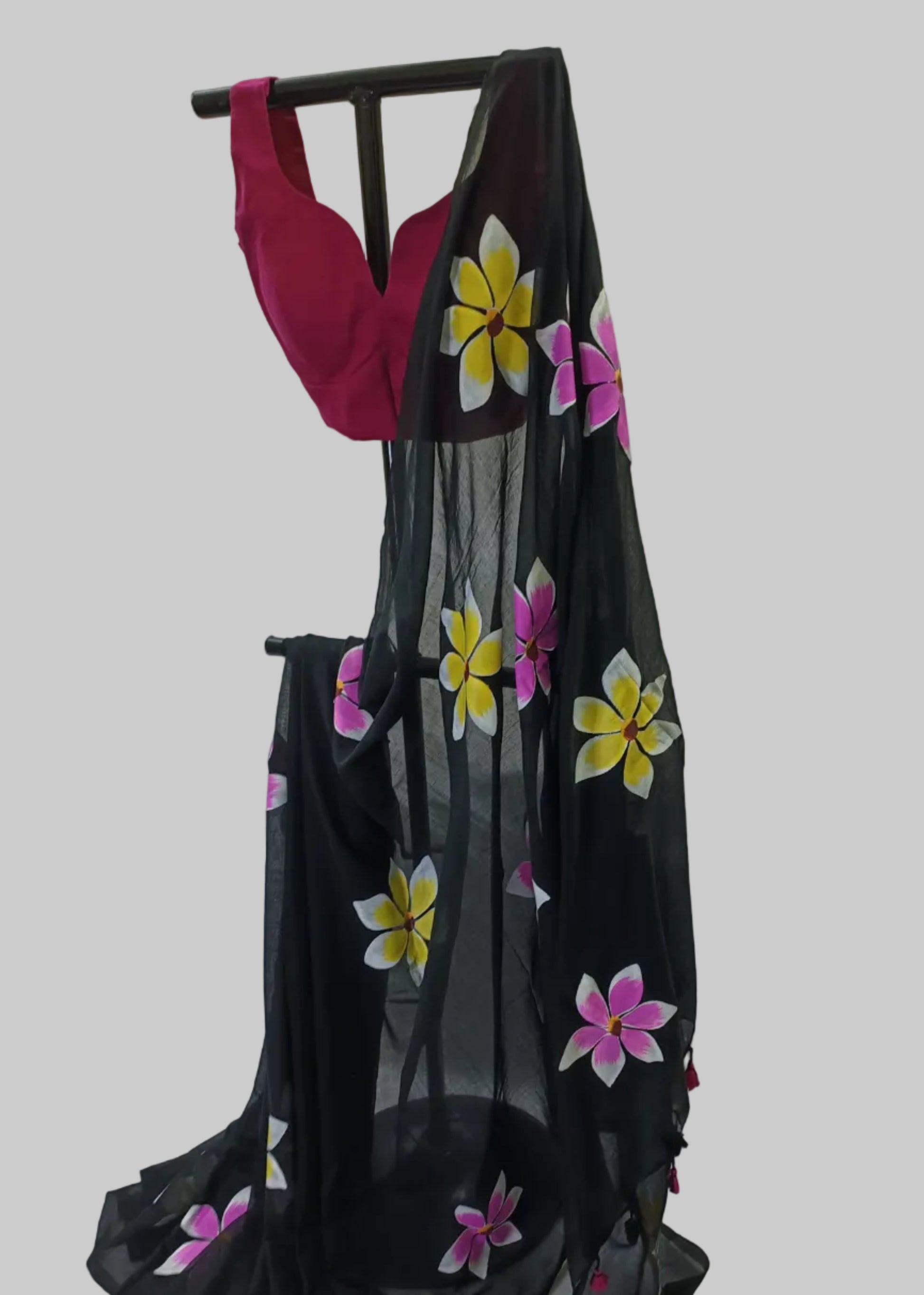 Black saree with floral patterns on a white background