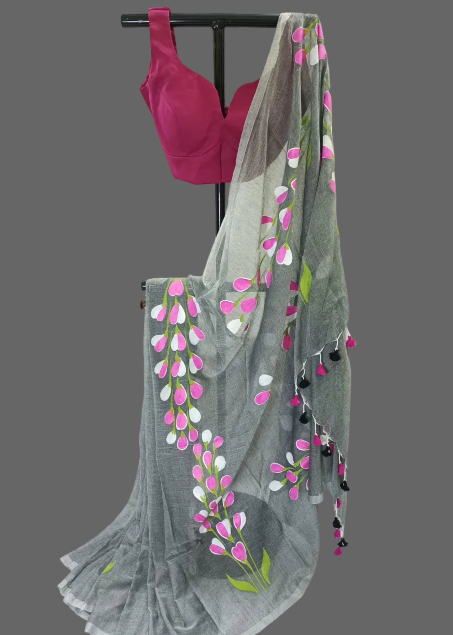 Gray saree with floral patterns and pink blouse on a white background