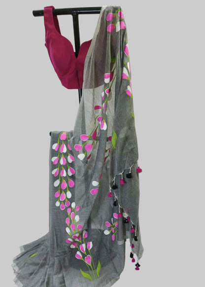 Gray saree with floral patterns and pink blouse on a white background