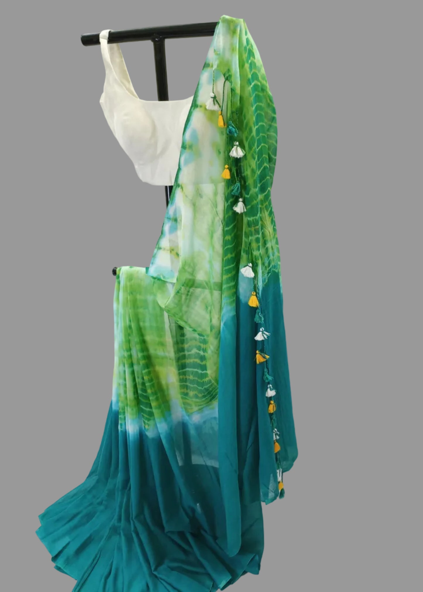 Green and blue saree with leaf pattern on a white background