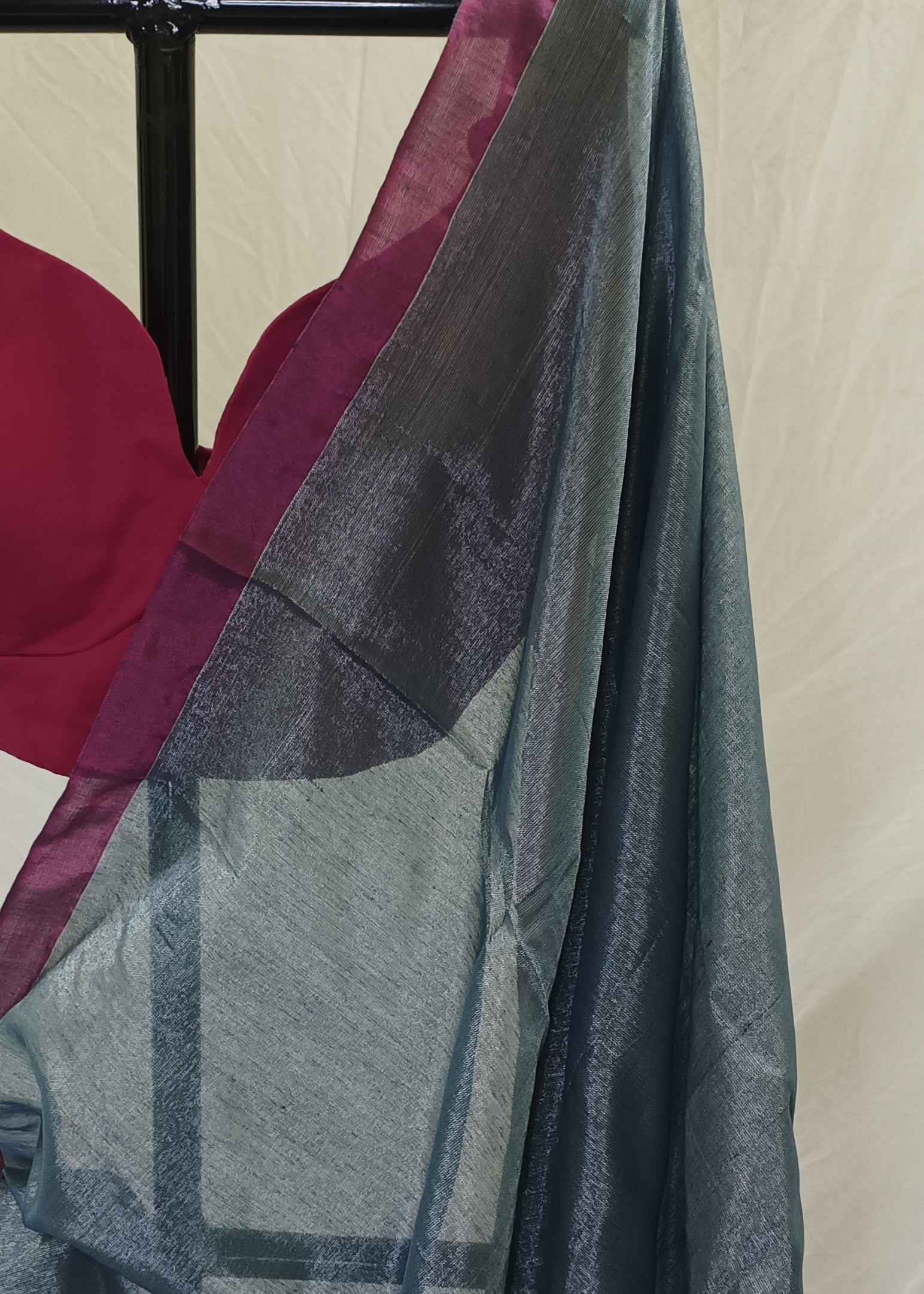 Close-up of a dark blue fabric with geometric patterns draped over a surface.